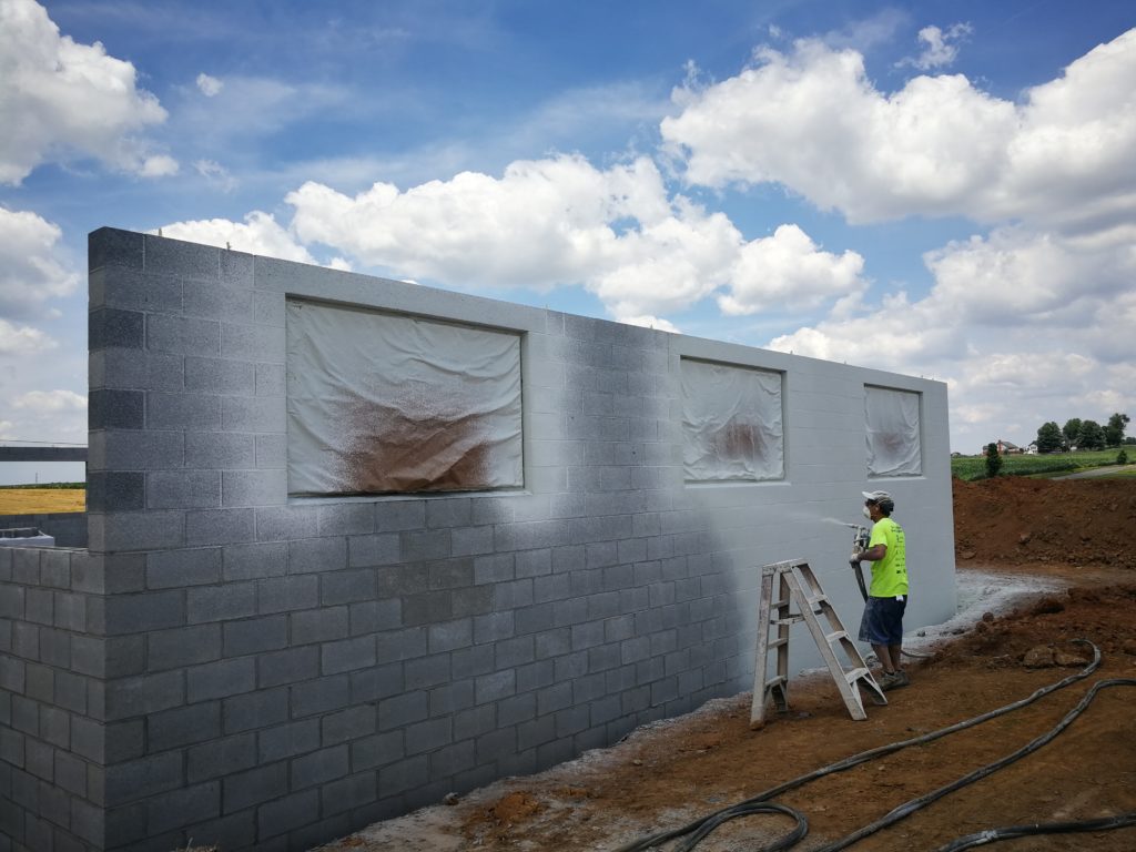 Our cementseal is applied to bare block. We like to spray the block below final grade to ensure a good seal. The cementseal will adhere to the block for the life of the building. Giving you a base coat that can be topcoated with paint and freshed up for years to come. The cementseal can be left as is providing a hydrostatic barrier for the building until you desire to paint for a fresh look.